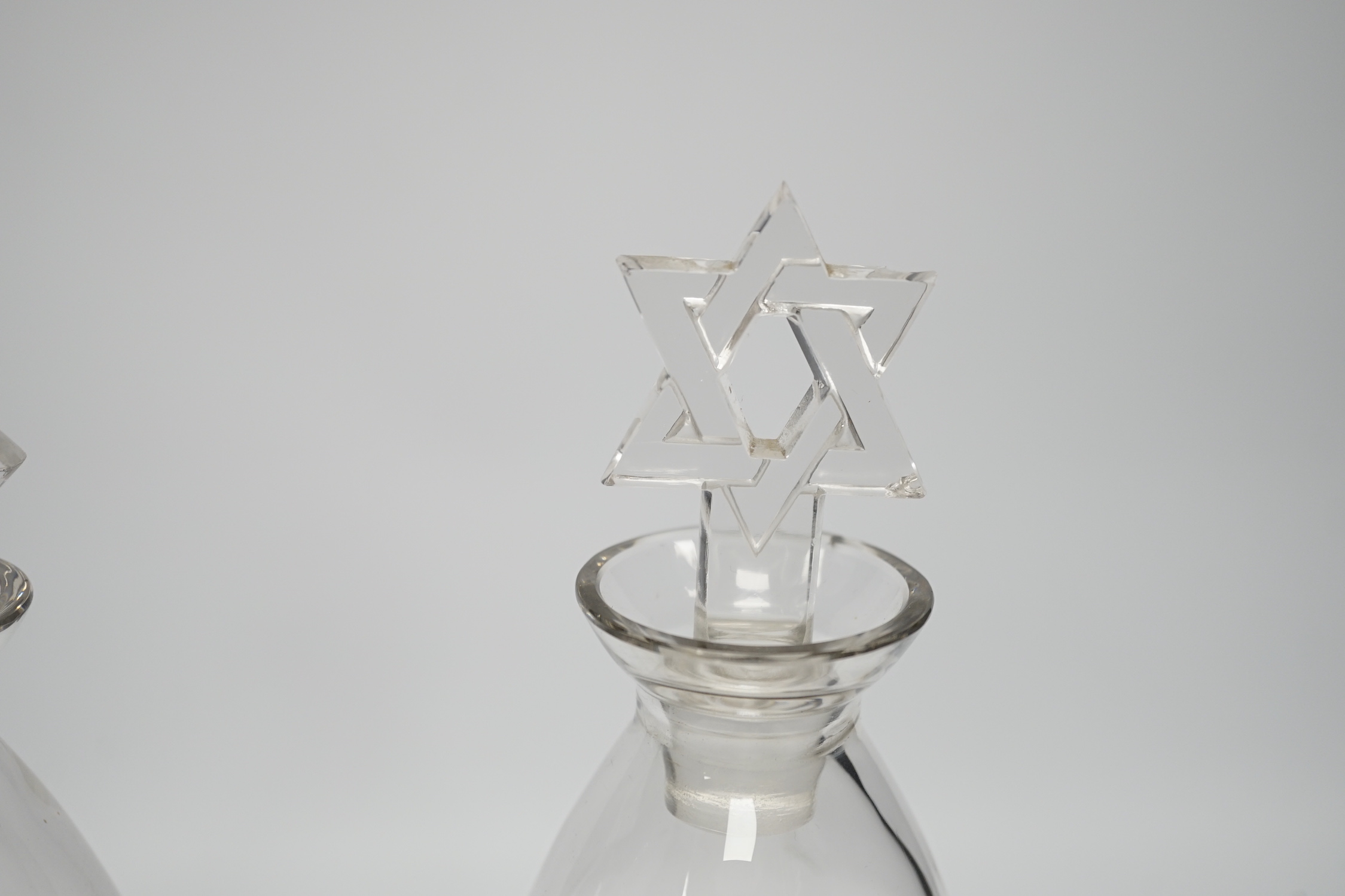 Two R. Lalique decanters, one with a Celtic knot stopper, the other the Star of David, tallest 27cm high (mark to base)